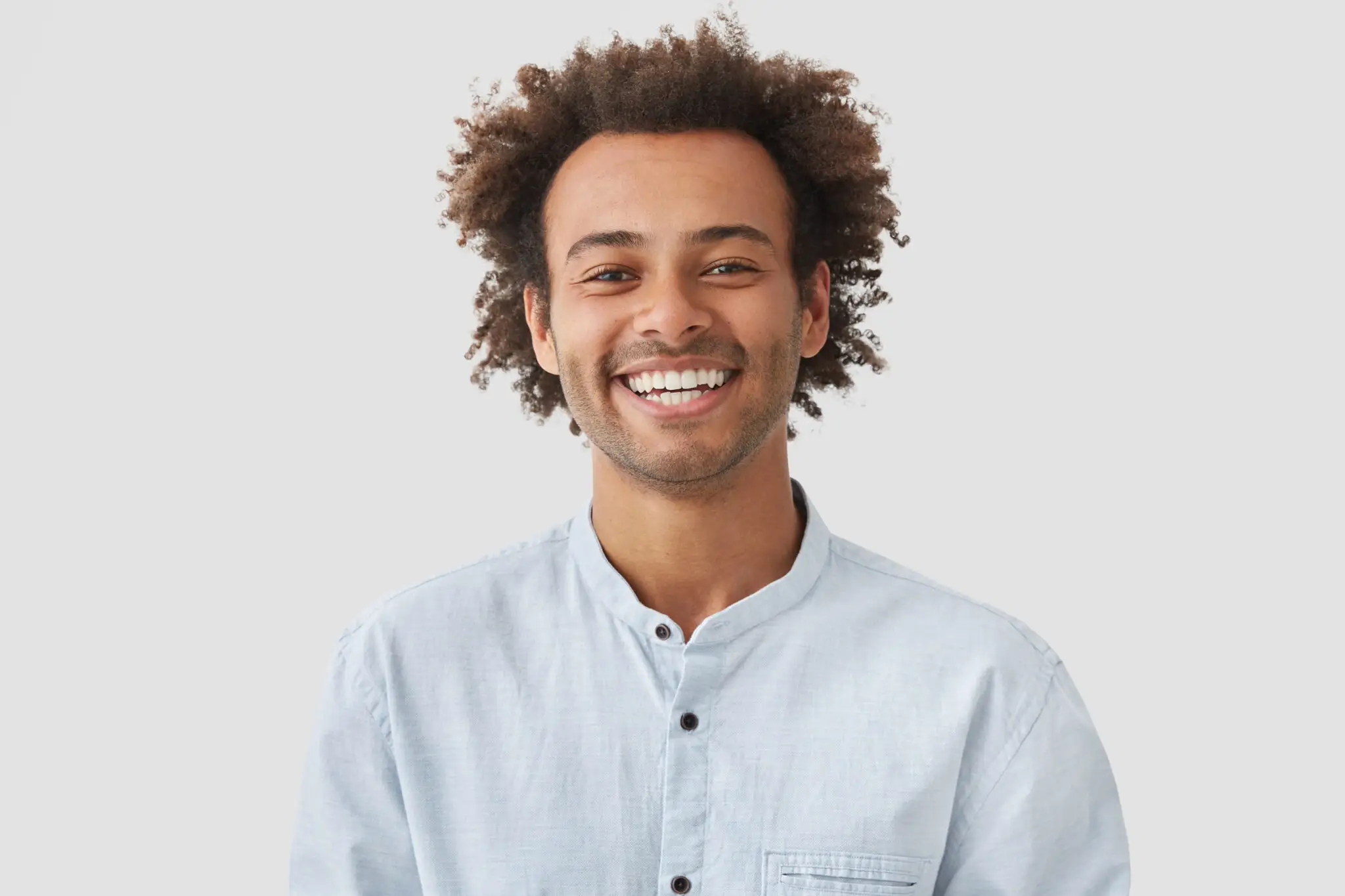 Happy Man Student With Afro Hairdo Shows White Teeth Being Good Mood After Classes 2048x1365